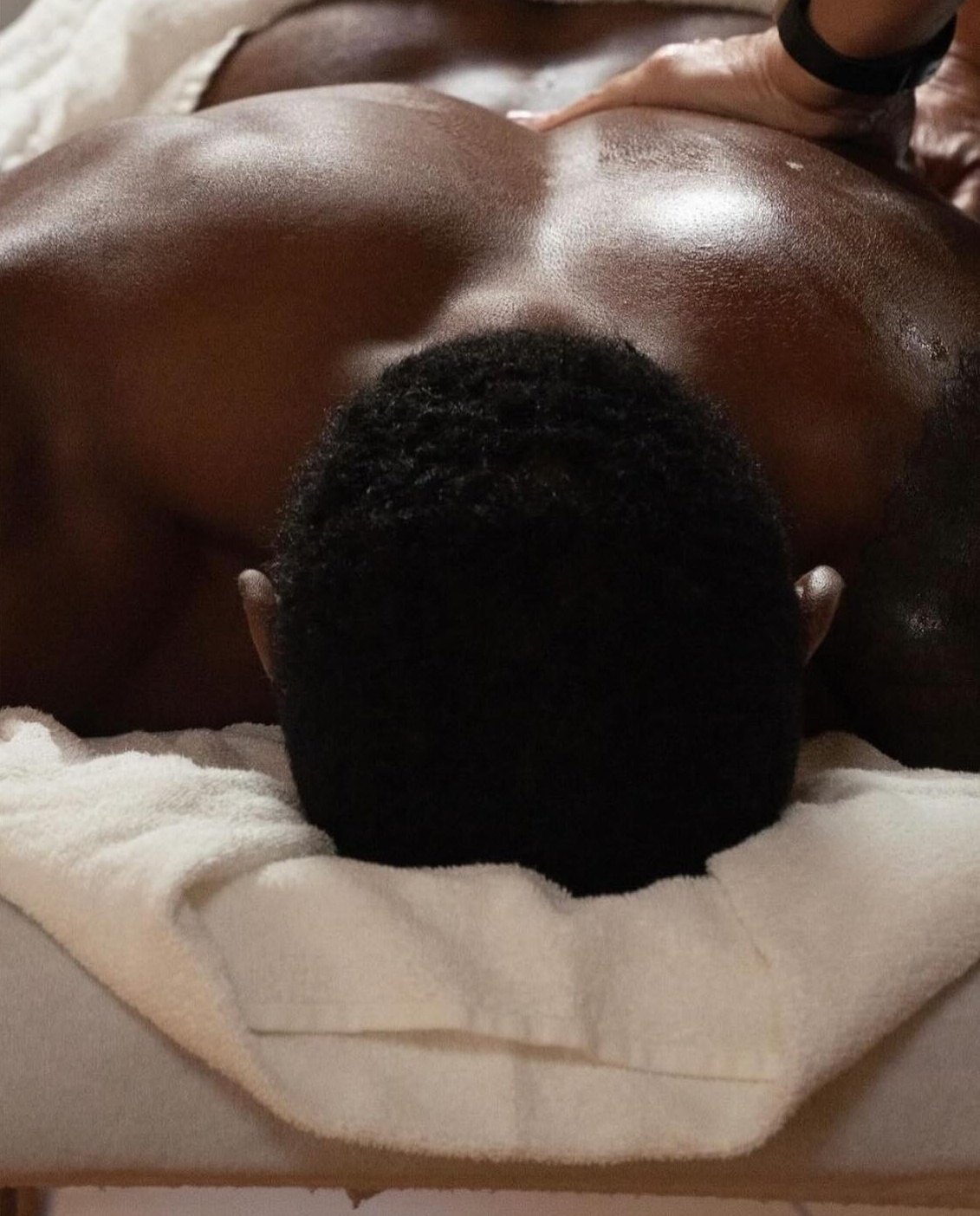 A remedial massage on an athlete's back and shoulders